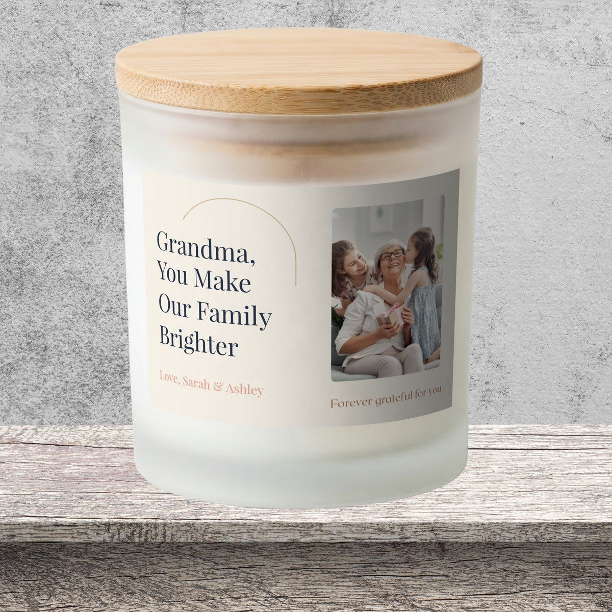 DESIGN E - You Make Our Family Brighter personalized frosted candle on a stone backdrop