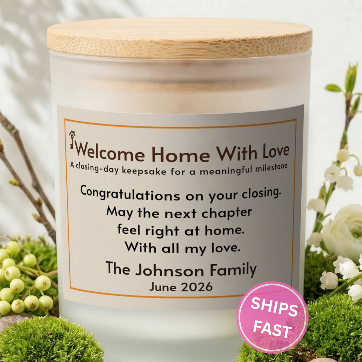 Welcome Home With Love personalized frosted candle with bamboo lid in a lifestyle scene with greenery