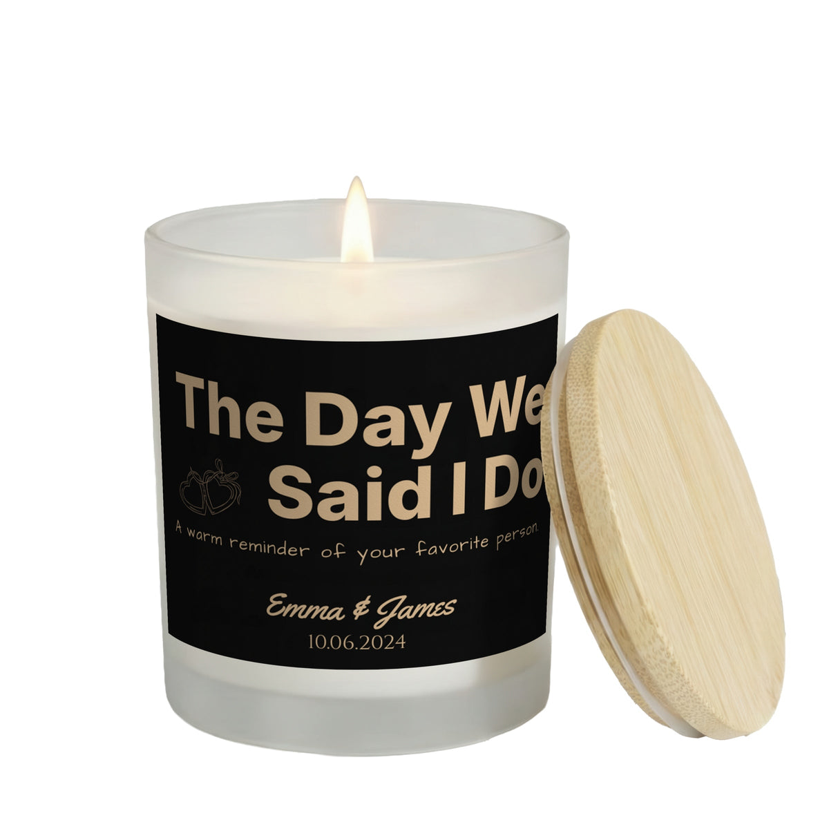The Day We Said I Do personalized frosted candle, lit with the bamboo lid set aside, on a white background