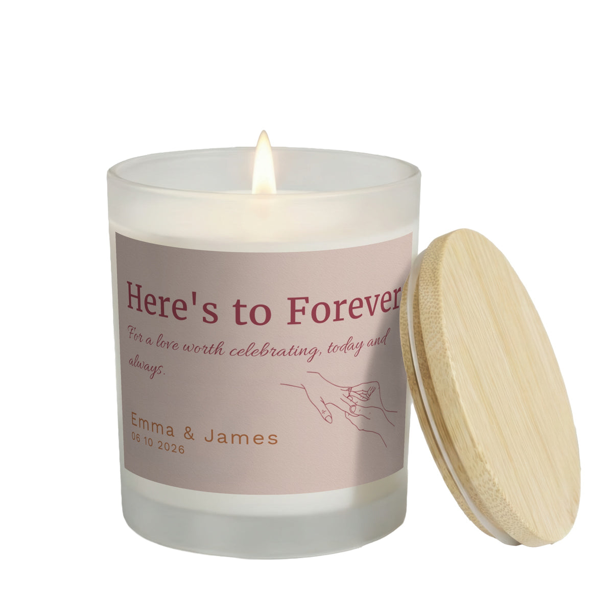 Here's to Forever personalized frosted candle, lit with the bamboo lid set aside, on a white background
