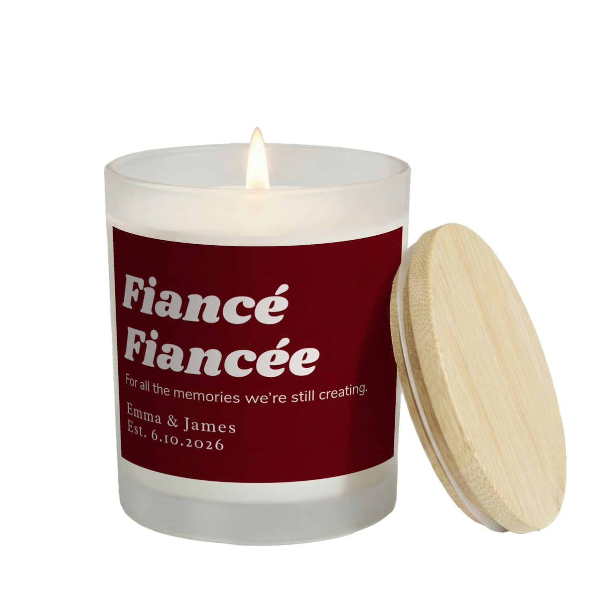 All the Memories We're Still Creating personalized frosted candle, lit with the bamboo lid set aside, on a white background