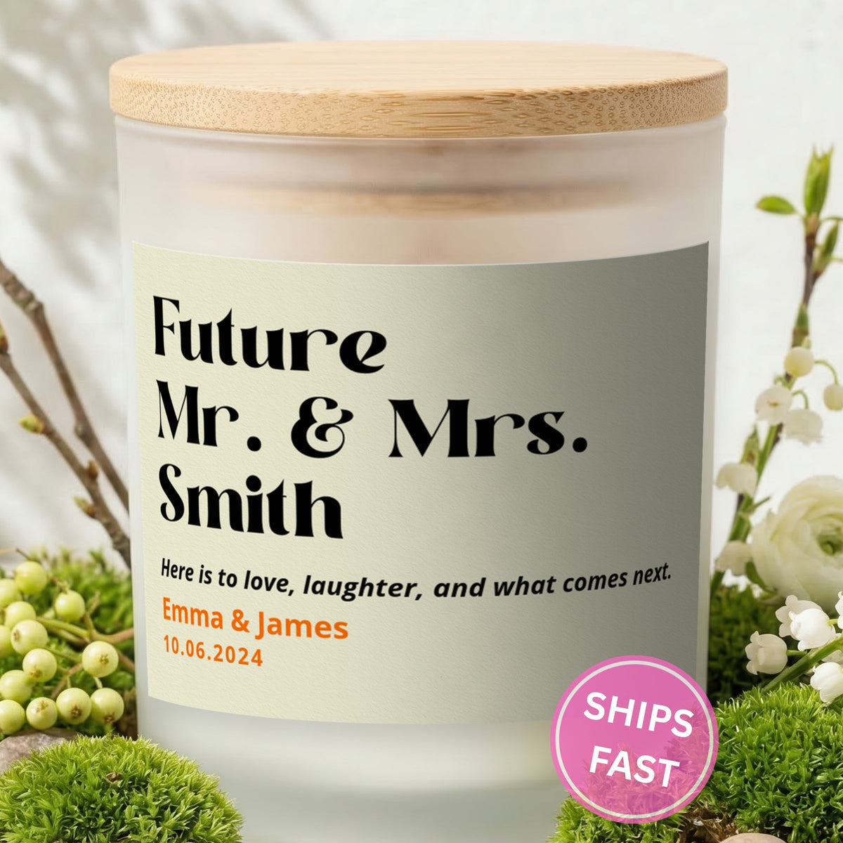 Here Is to What Comes Next personalized frosted candle with bamboo lid in a lifestyle scene with greenery