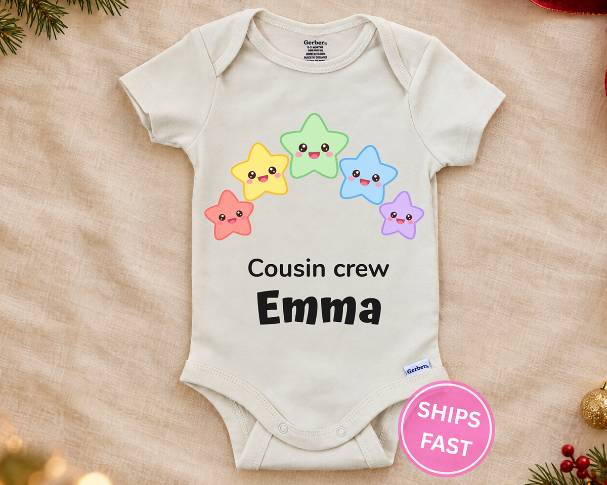 Cousin Crew personalized baby bodysuit with the rainbow stars design on a cream blanket