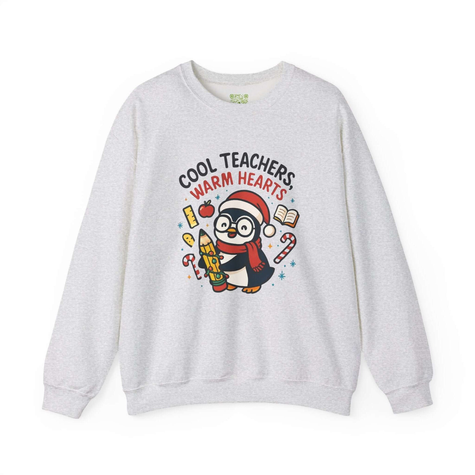 White sweatshirt featuring a cute penguin graphic with the text 'Cool Teachers Warm Hearts', perfect for teacher holiday gifts.