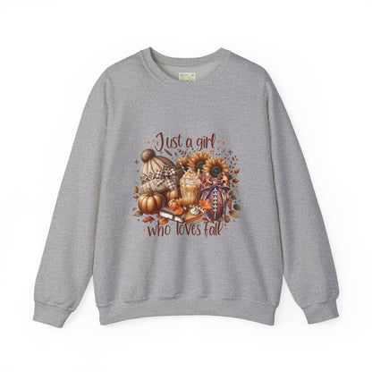 Woman wearing a cozy white sweatshirt with autumn-themed graphic saying 'Just a girl who loves fall'.