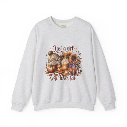 Woman wearing a cozy white sweatshirt with autumn-themed graphic saying 'Just a girl who loves fall'.