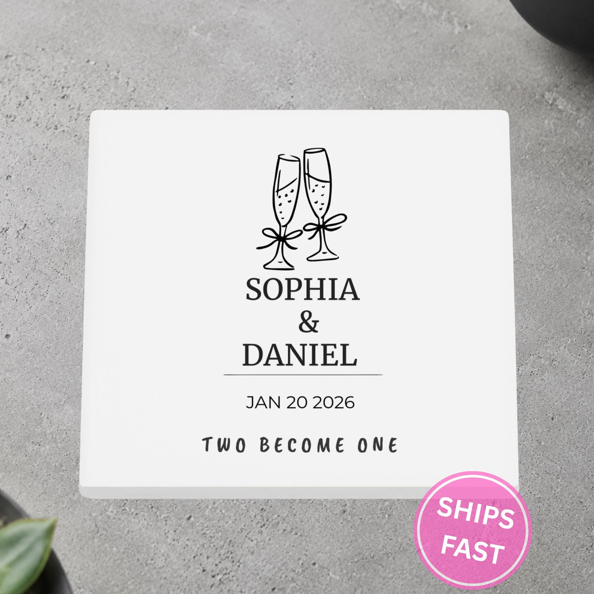Champagne Toast Two Become One personalized ceramic coaster on a gray stone surface