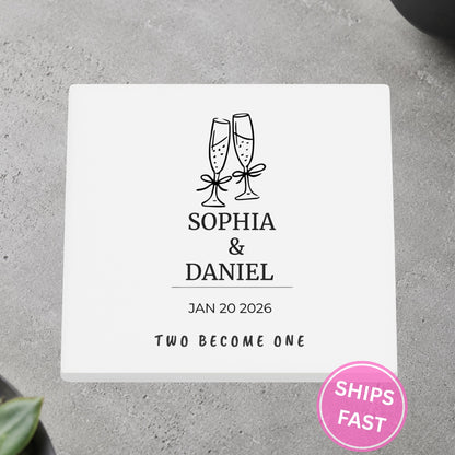Champagne Toast Two Become One personalized ceramic coaster on a gray stone surface