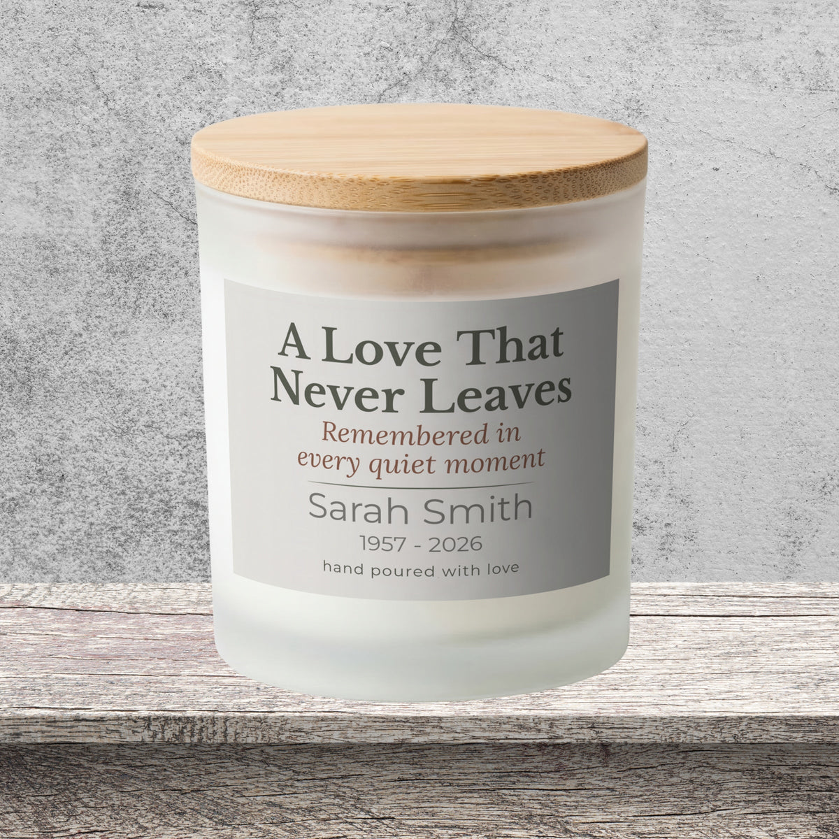 DESIGN B - A Love That Never Leaves personalized frosted candle on a stone backdrop