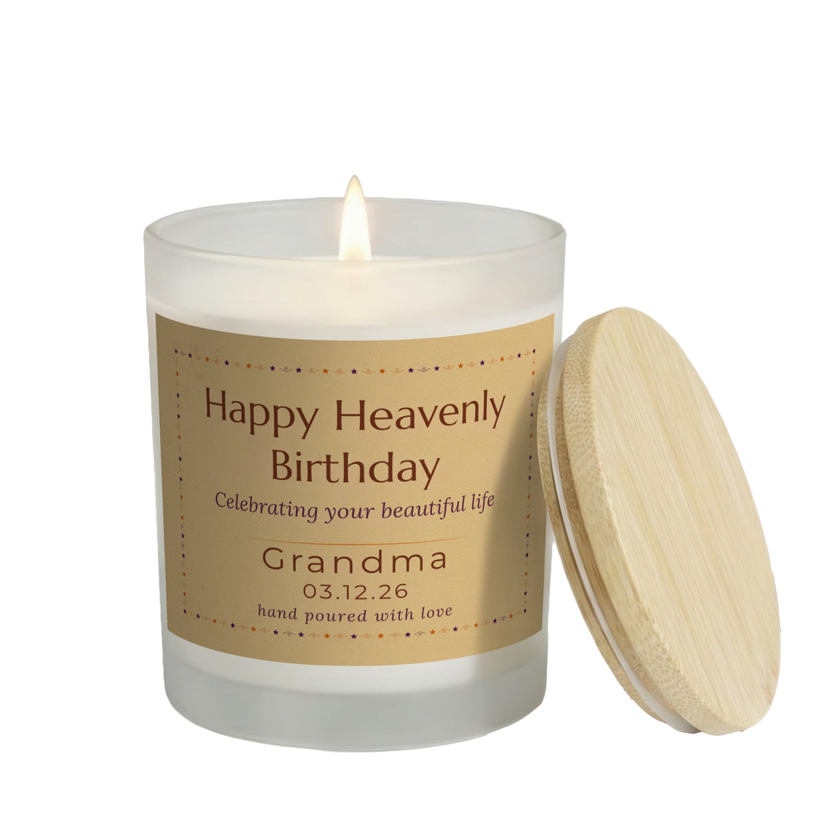 Happy Heavenly Birthday personalized frosted candle, lit with the bamboo lid set aside, on a white background