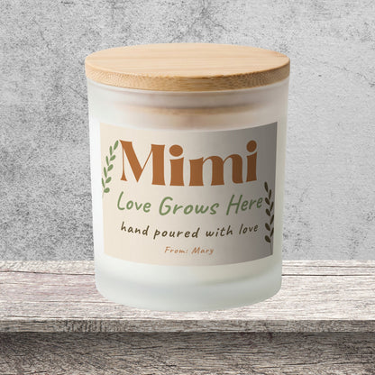 DESIGN D - Love Grows Here personalized frosted candle on a stone backdrop