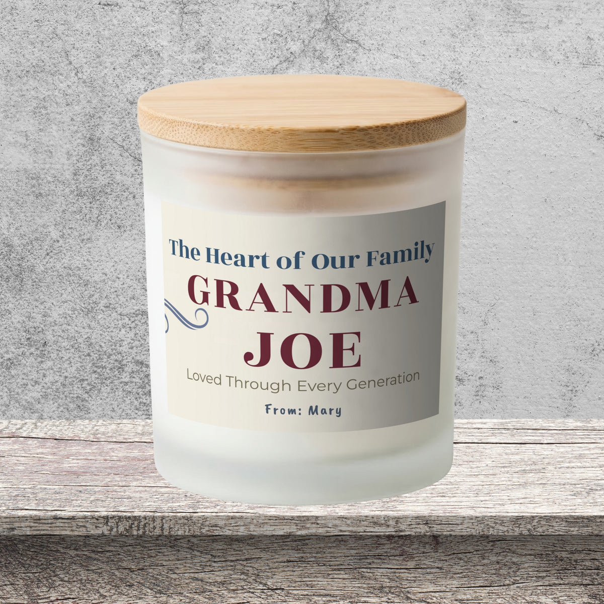DESIGN B - The Heart of Our Family personalized frosted candle on a stone backdrop