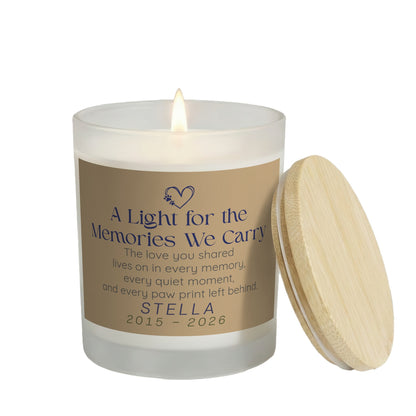 Every Paw Print Left Behind personalized frosted candle, lit with the bamboo lid set aside, on a white background