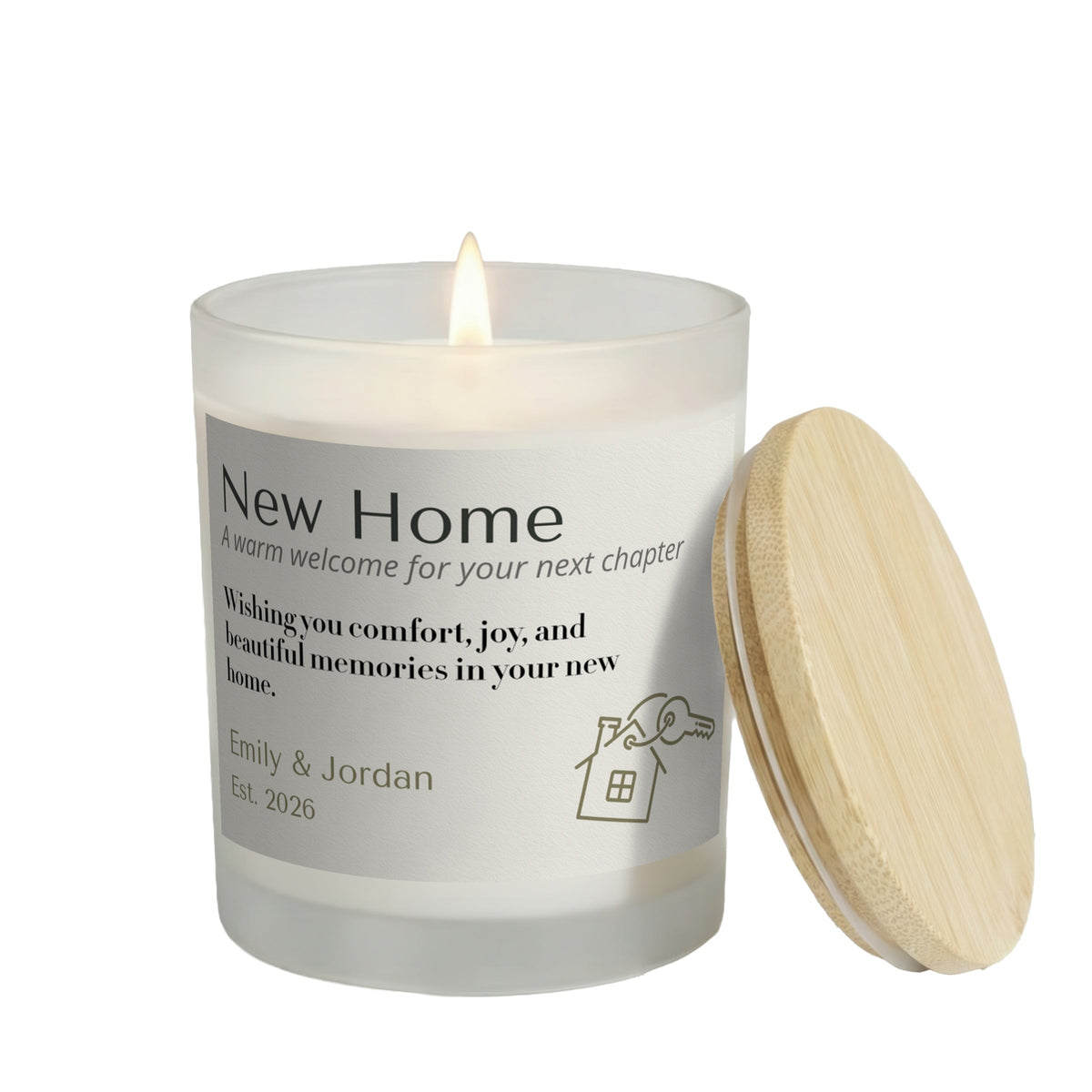 A Warm Welcome for Your Next Chapter personalized frosted candle, lit with the bamboo lid set aside, on a white background