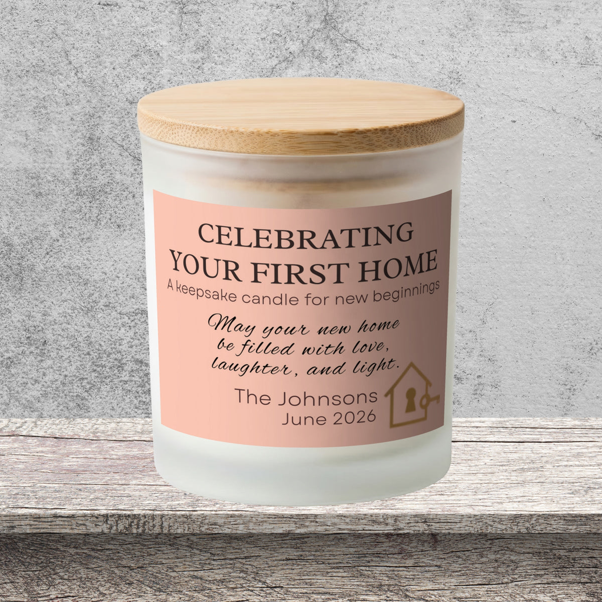 DESIGN A - Celebrating Your First Home personalized frosted candle on a stone backdrop