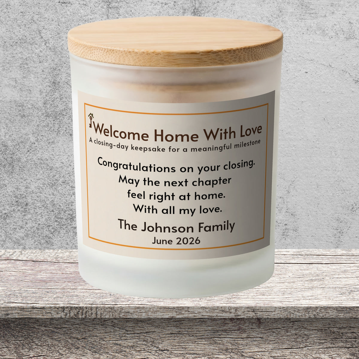 DESIGN E - Welcome Home With Love personalized frosted candle on a stone backdrop