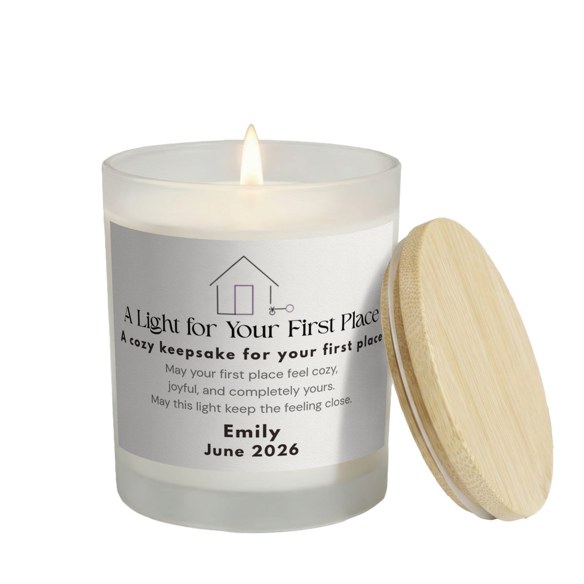 A Light for Your First Place personalized frosted candle, lit with the bamboo lid set aside, on a white background