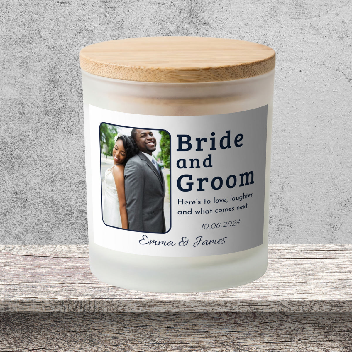 DESIGN F - Here's to Love and Laughter personalized frosted candle on a stone backdrop