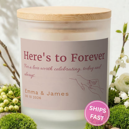 Here's to Forever personalized frosted candle with bamboo lid in a lifestyle scene with greenery