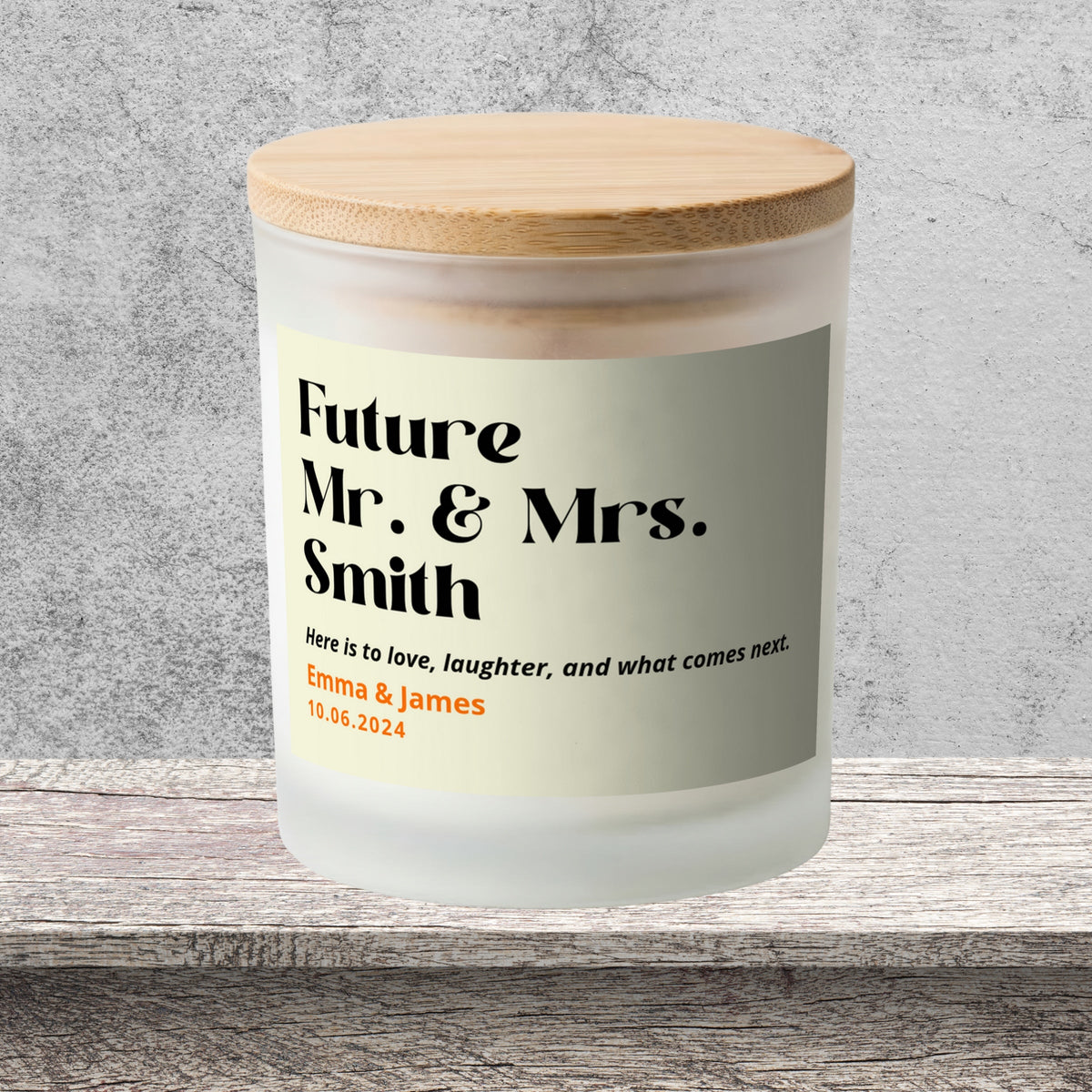 DESIGN F - Here Is to What Comes Next personalized frosted candle on a stone backdrop