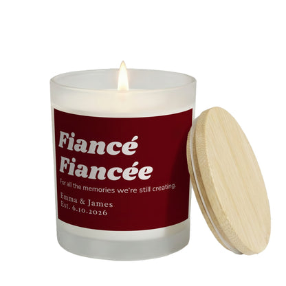 All the Memories We're Still Creating personalized frosted candle, lit with the bamboo lid set aside, on a white background