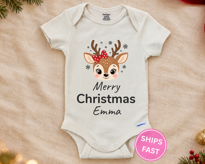 Merry Christmas reindeer personalized baby bodysuit laid flat on a soft blanket