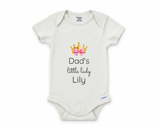 Dad's Little Lady personalized baby bodysuit with gold crown and pink bow on a white background