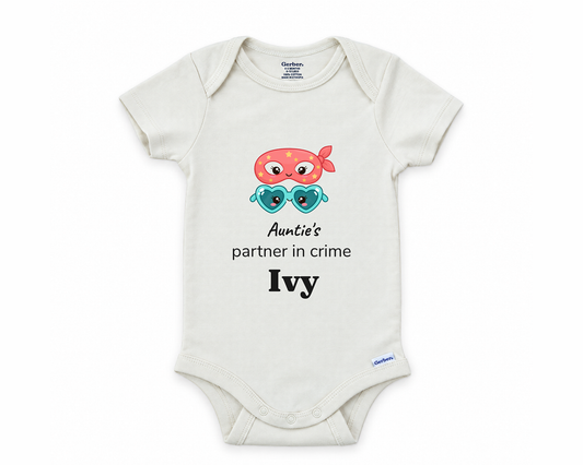 Auntie's Partner in Crime personalized baby bodysuit with bandit mask and heart sunglasses on a white background