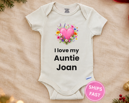 I Love My Auntie personalized baby bodysuit with wildflower heart on a cream blanket