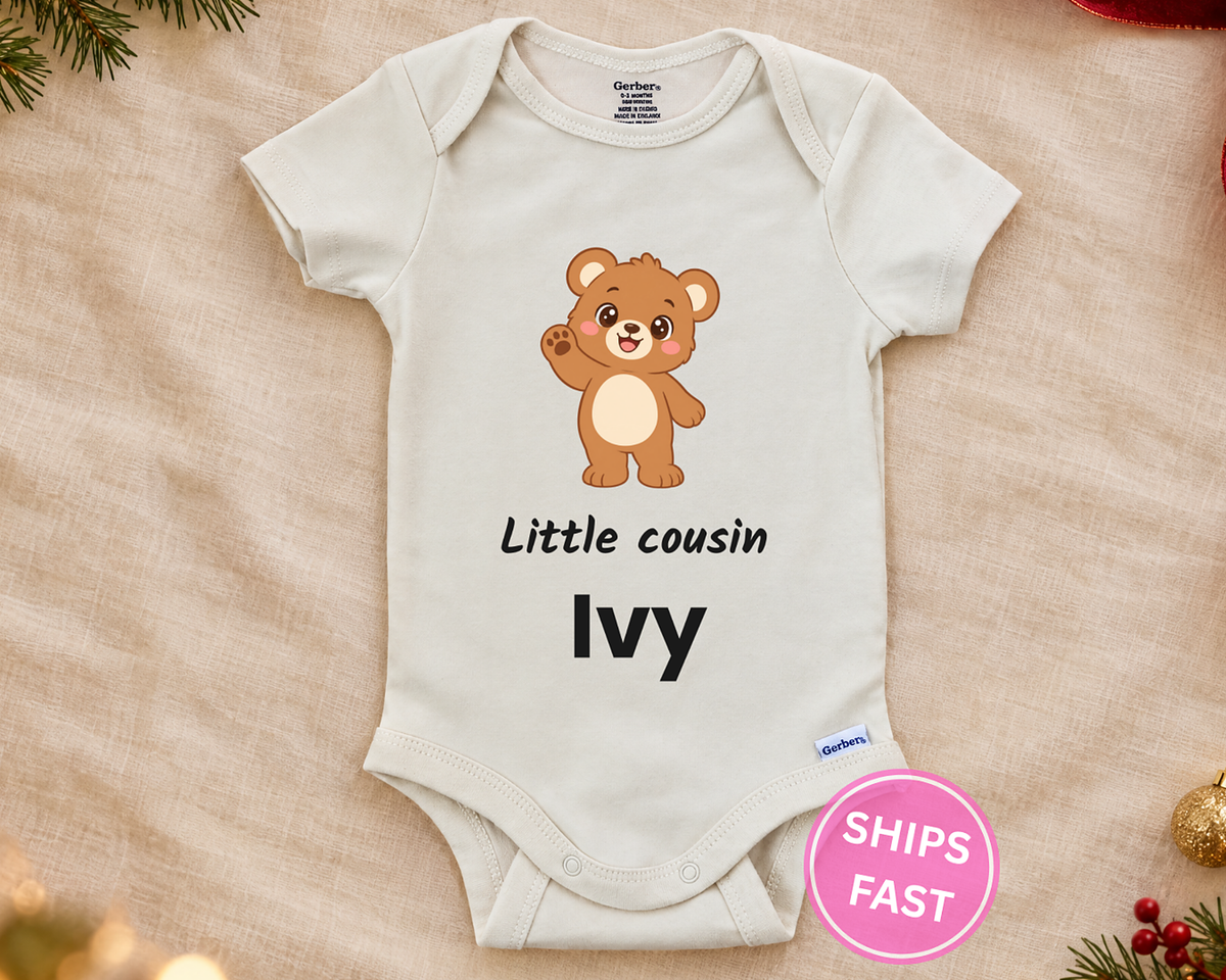 Little Cousin personalized baby bodysuit with the teddy bear design on a cream blanket