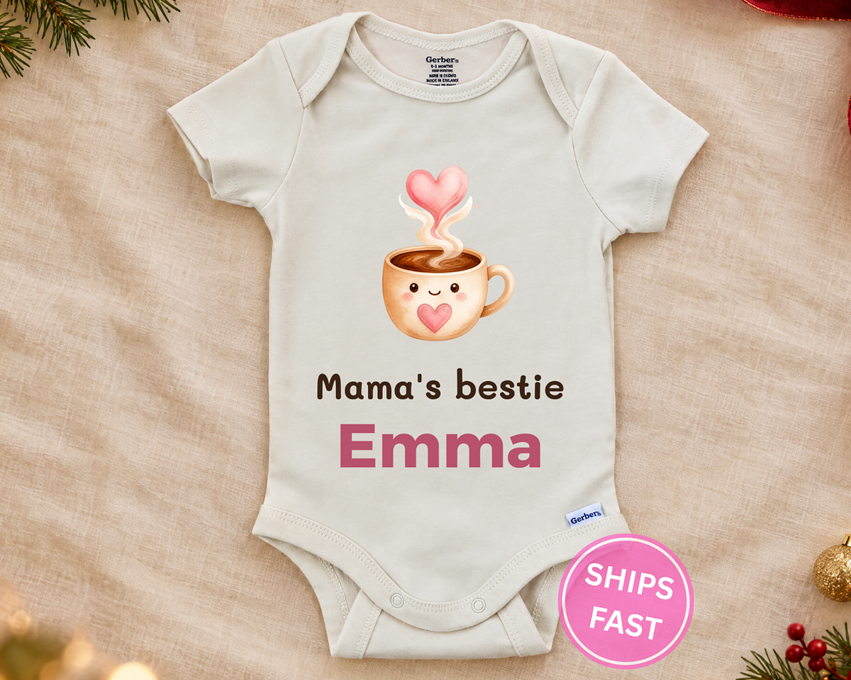 Mama's Bestie personalized baby bodysuit with the coffee cup design on a cream blanket