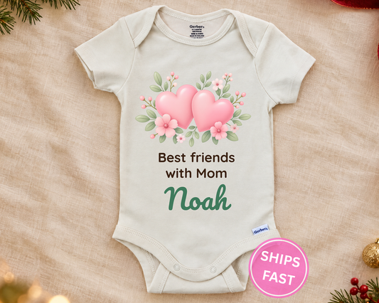 Best Friends With Mom personalized baby bodysuit with the hearts design on a cream blanket