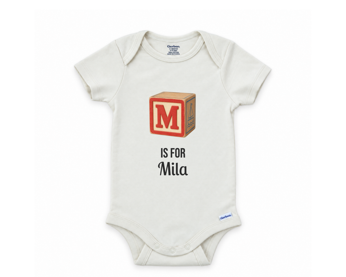 M is for Mila personalized baby bodysuit on a white background