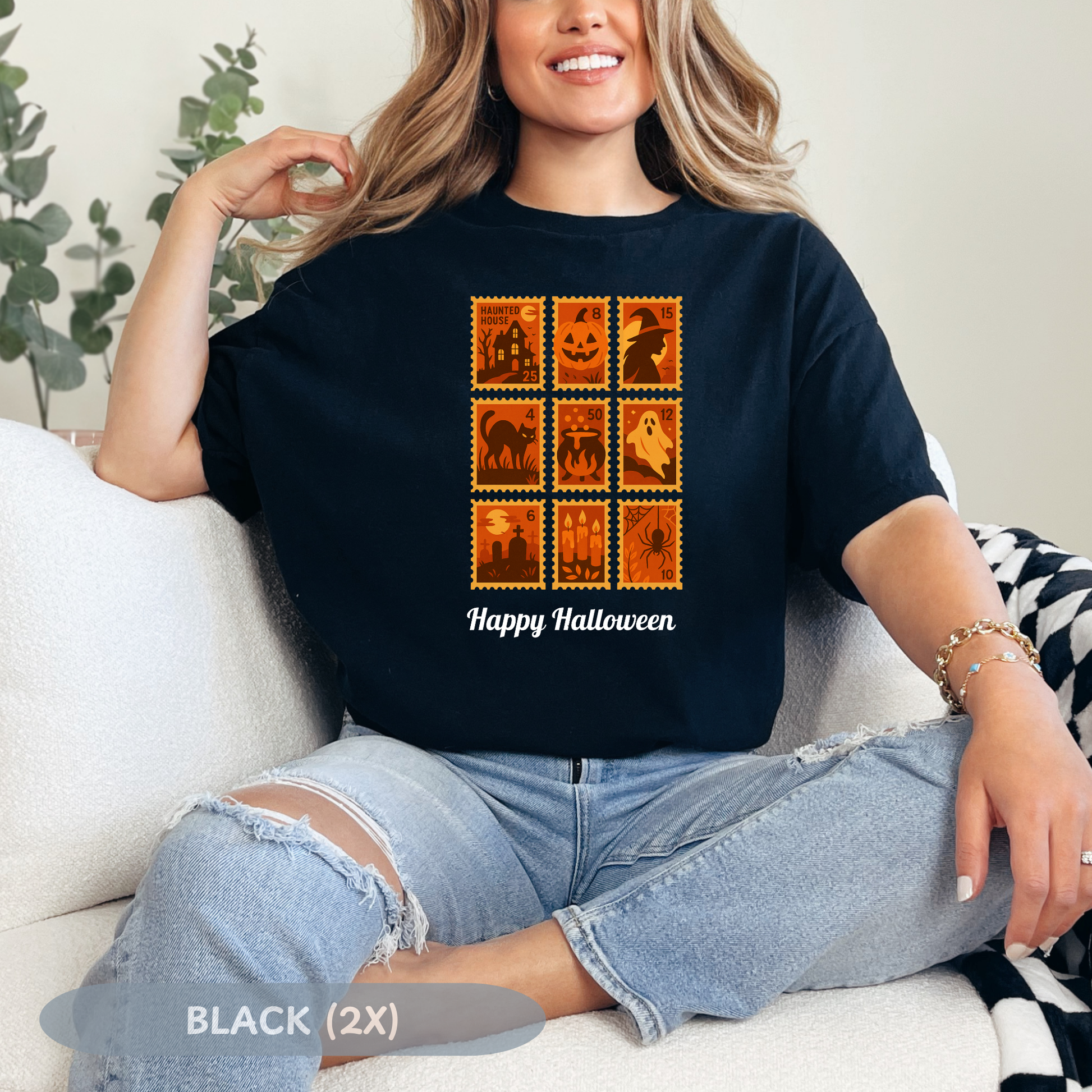 Woman wearing a black Halloween postage stamp t-shirt with spooky designs and the text 'Happy Halloween'.
