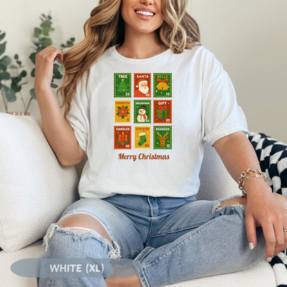 Woman wearing a Christmas postage stamp shirt featuring festive designs and the text 'Merry Christmas'.