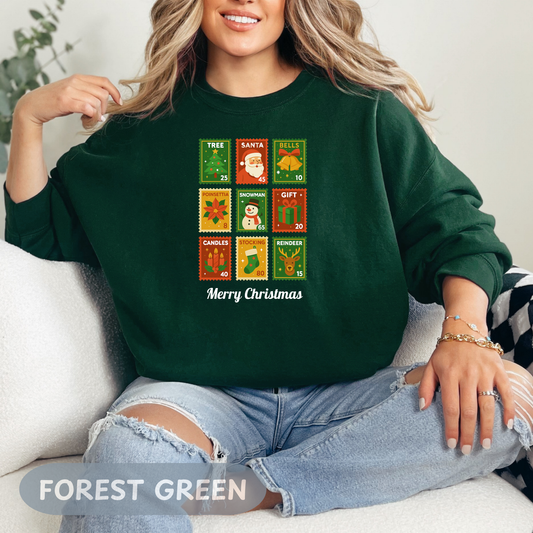 Postage stamp Christmas sweater in forest green featuring holiday designs and 'Merry Christmas' text.
