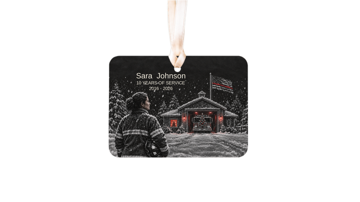 thin red line firefighter ornament with a snowy fire station night scene on a white background